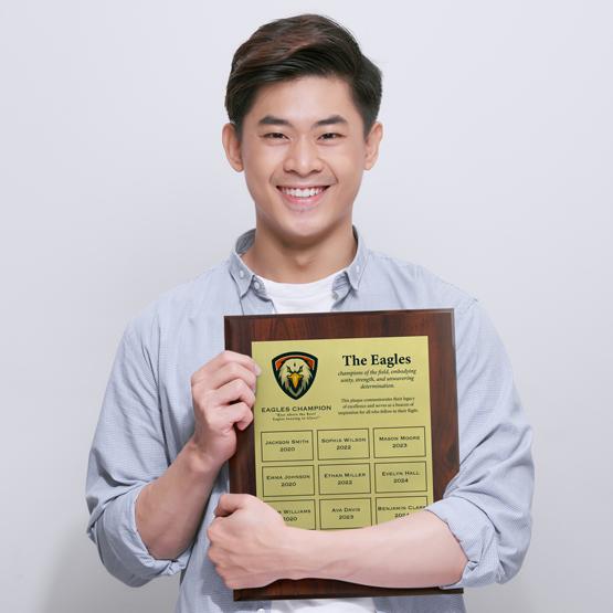 Young Student Holding A Custom Printed Economy Aluminum Perpetual Plaque For School Awards.