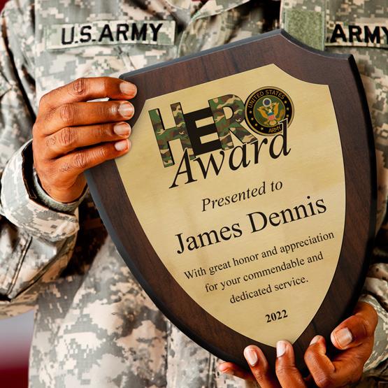 Personalized Full Color Shield Plaque with Gold Metal for Army Hero James Dennis held by soldier.