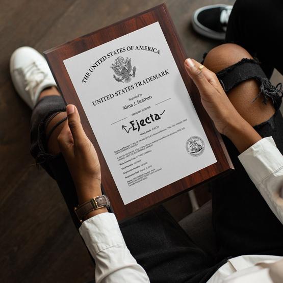 Man holding a Trademark Plaque