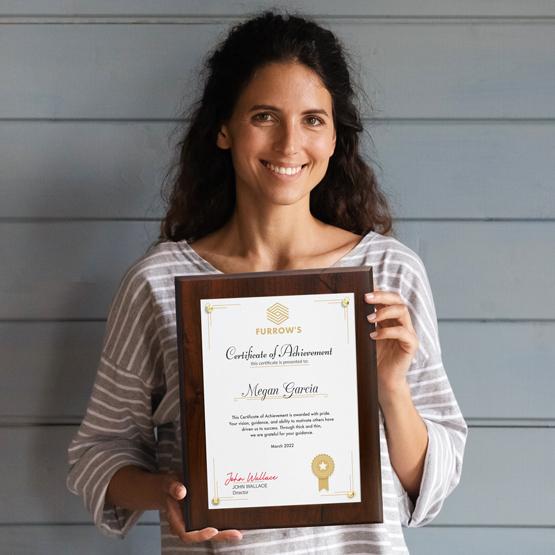 Certificate Plaque Kit with Plexiglass and Gold Pins being held by a happy woman near door.