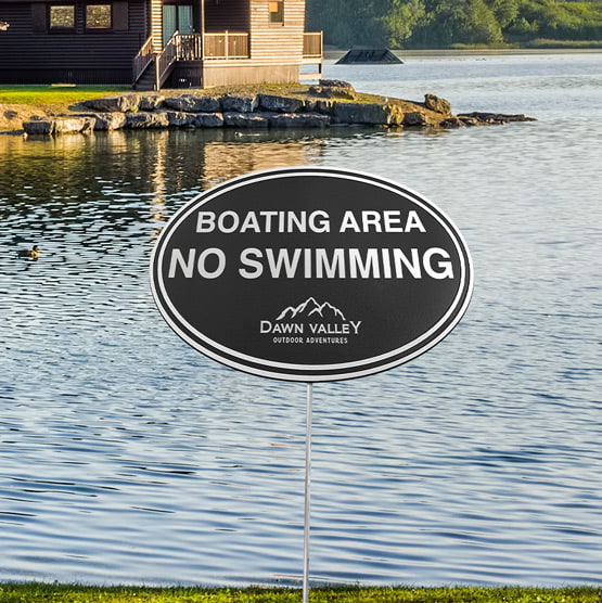 Oval Cast Aluminum Black And Silver Sign With Stand On Lake Shore With Custom Boating Area No Swimming Text