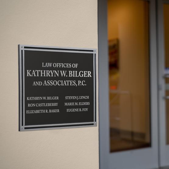 Black And Silver Rectangle Cast Aluminum Sign Mounted With Screws On Office Wall Featuring Custom Law Staff List