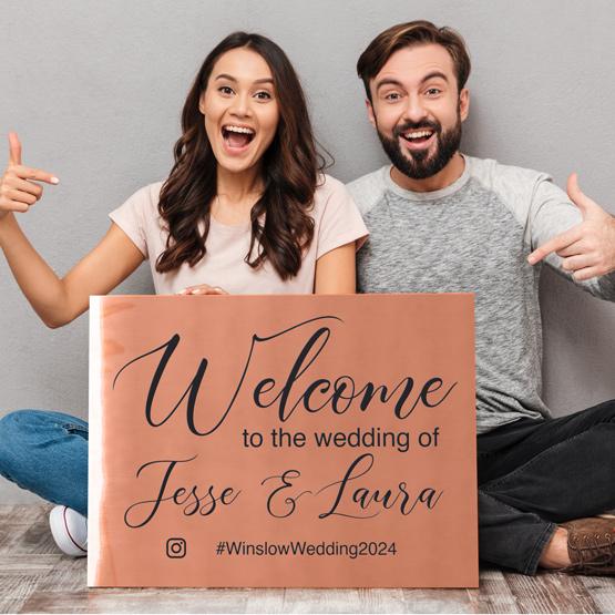 Custom Engraved Copper Metal Sign Held By Couple Who Created A Sign For Their Upcoming Wedding.