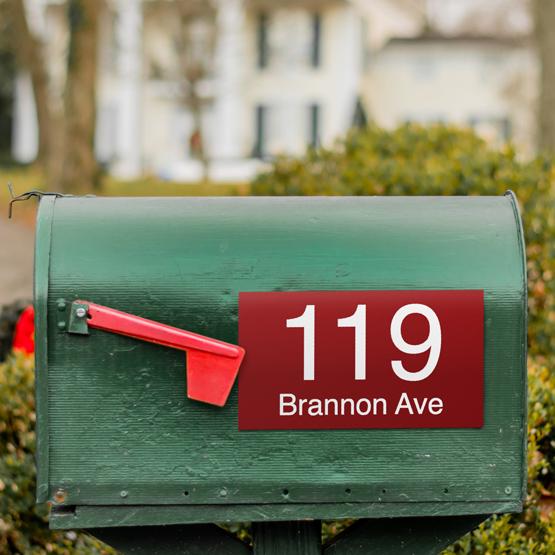 Custom Engraved Plastic Address Sign Plaque attached to a Green Mailbox and engraved with address.