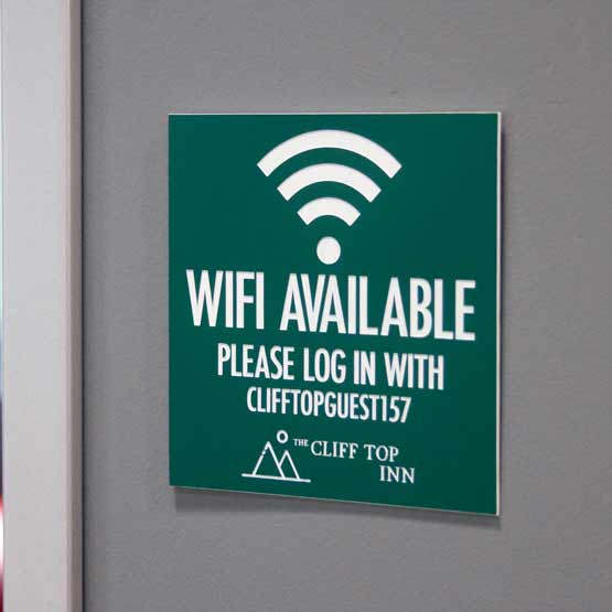 Plastic WiFi Sign on Wall Near Door