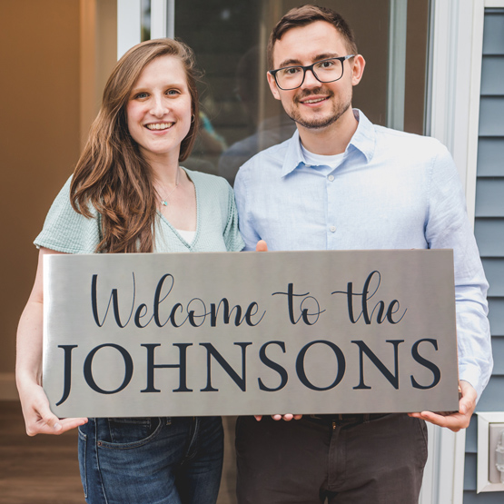 Couple with a custom metal sign